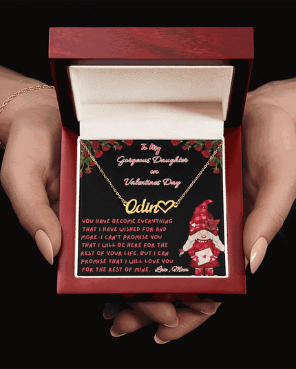 yellow gold name heart necklace in a luxury box in a model's hands