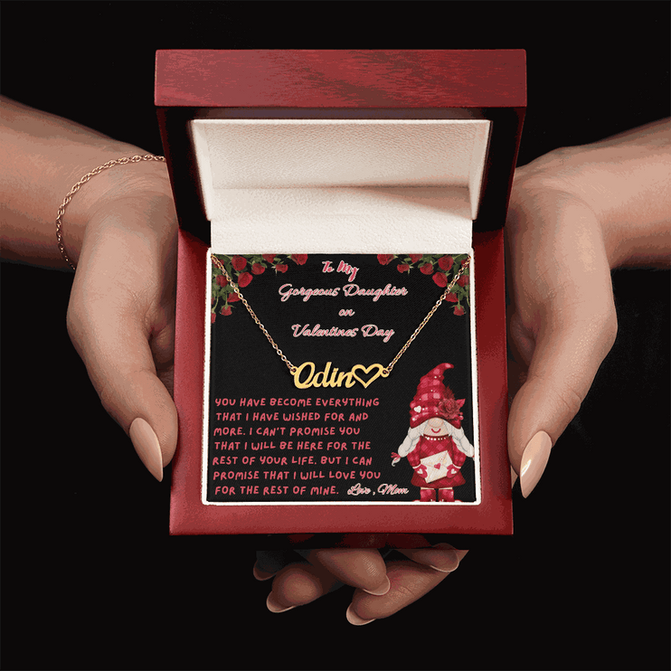 yellow gold name heart necklace in a luxury box in a model's hands