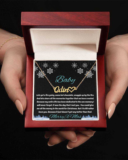 gold name heart necklace in luxury box in model's hands