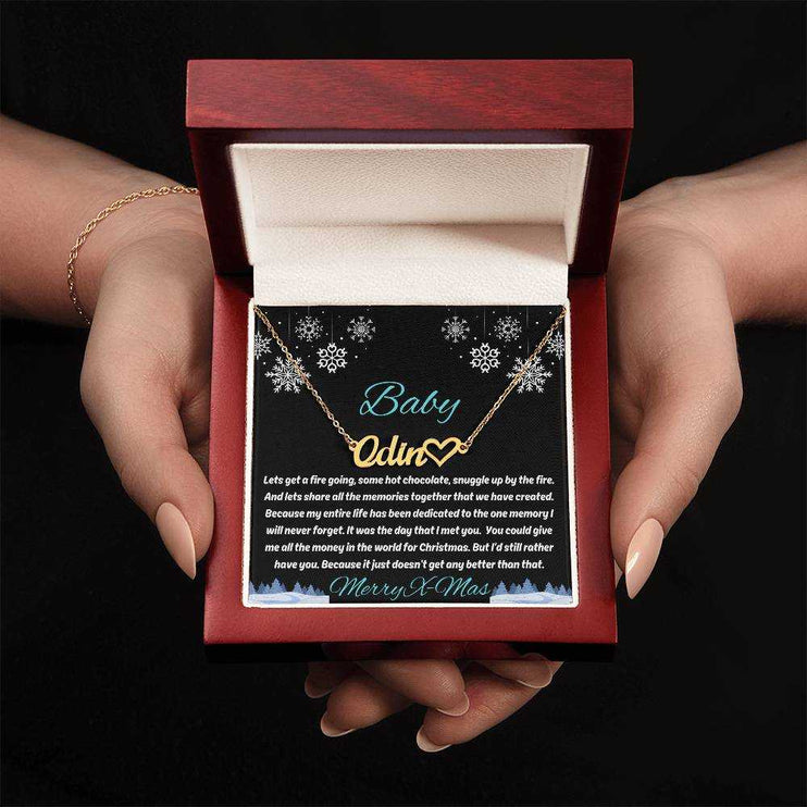 gold name heart necklace in luxury box in model's hands