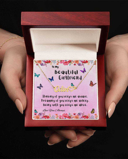 18k name heart necklace in luxury box in model's hands