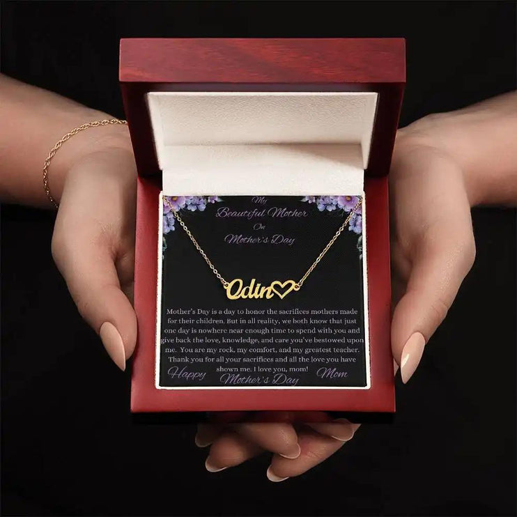 yellow gold name heart necklace in mahogany box in models hands