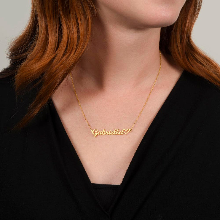 gold variant name with heart necklace around the neck of model