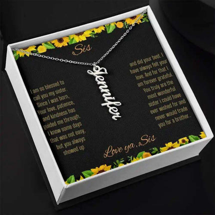 Vertical Name Necklace with a polished stainless-steel finish on a To Sis From Sis greeting card close up angled slightly right