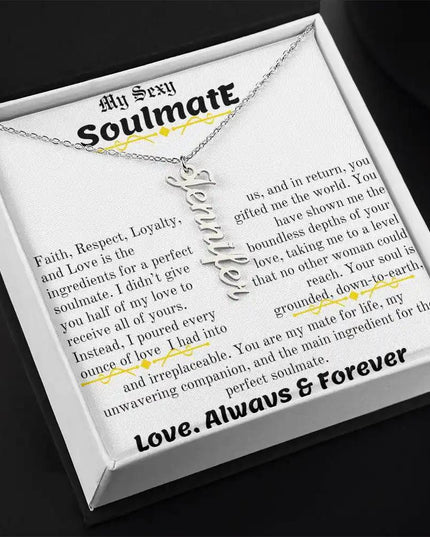 a polished stainless steel vertical name necklace in a two-tone box angled left