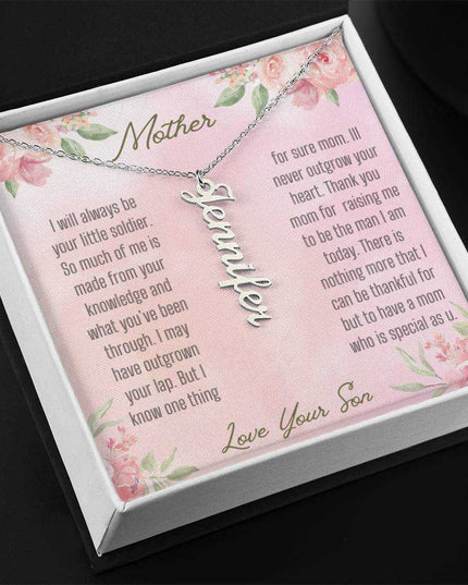 A polished stainless-steel vertical name necklace in a two-tone box.
