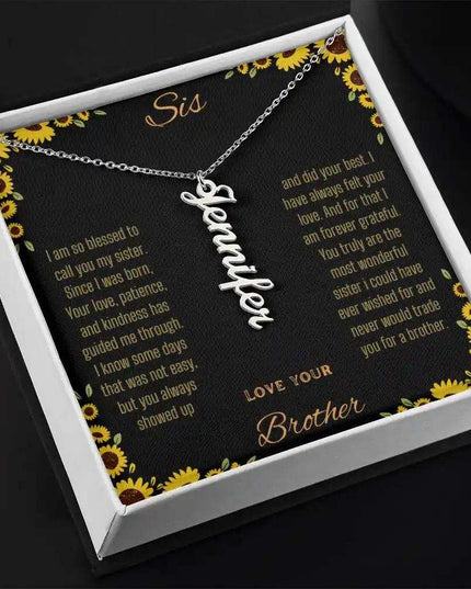 Vertical Name Necklace with a polished stainless-steel charm on a to sis from brother greeting card in a two-tone box angled slightly to the right