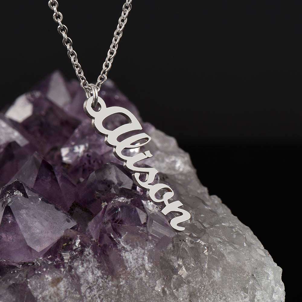 polished stainless-steel vertical name necklace on a geode rock