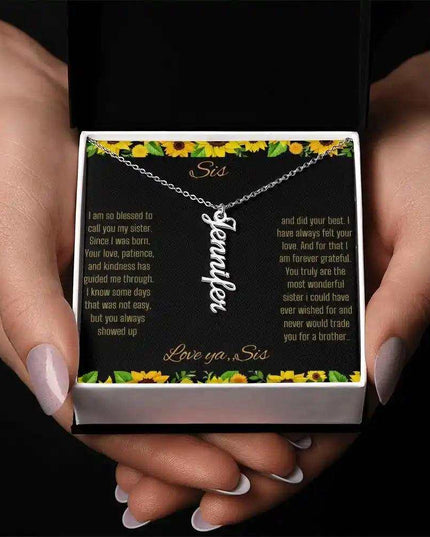 Vertical Name Necklace with a polished stainless-steel finish on a To Sis From Sis greeting card in a models hands