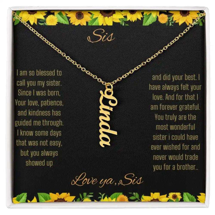Vertical Name Necklace with a yellow gold finish on a To Sis From Sis greeting card close up