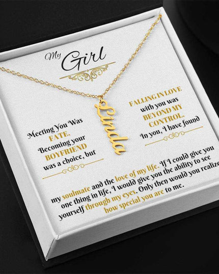 gold vertical name necklace in a soft box angled left