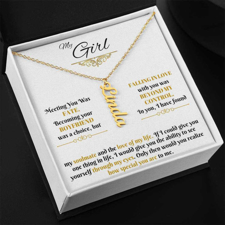 gold vertical name necklace in a soft box angled left