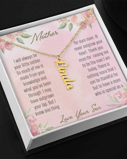 A yellow gold finish vertical name necklace in two-tone box angled to left.