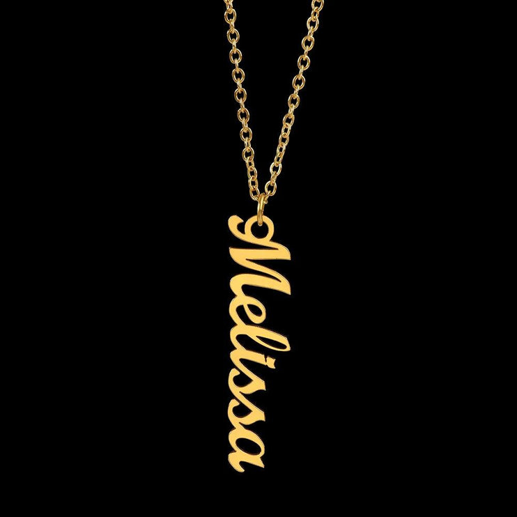 gold vertical name necklace on a black background