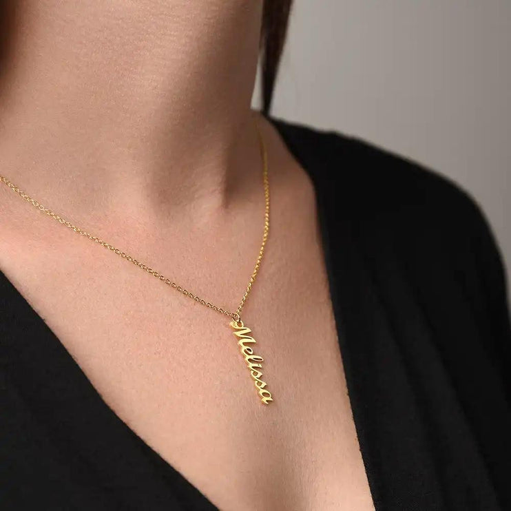 gold vertical name necklace on model's neck