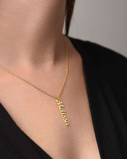yellow gold vertical name necklace on a model's neck