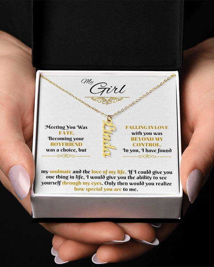 gold vertical name necklace in a soft box in model's hands