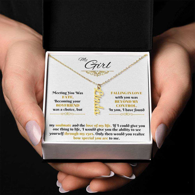 gold vertical name necklace in a soft box in model's hands