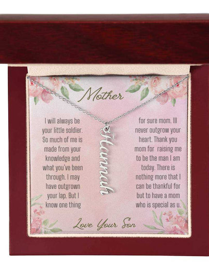 A polished stainless-steel vertical name necklace in a mahogany box.
