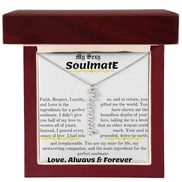 a polished stainless steel vertical name necklace in a mahogany box