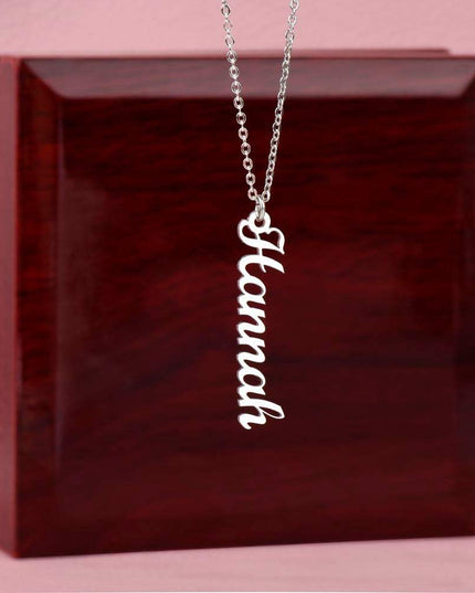 polished stainless-steel vertical name necklace on top of luxury box