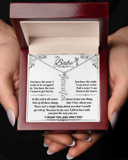 polished stainless-steel vertical name necklace in a luxury box in hands