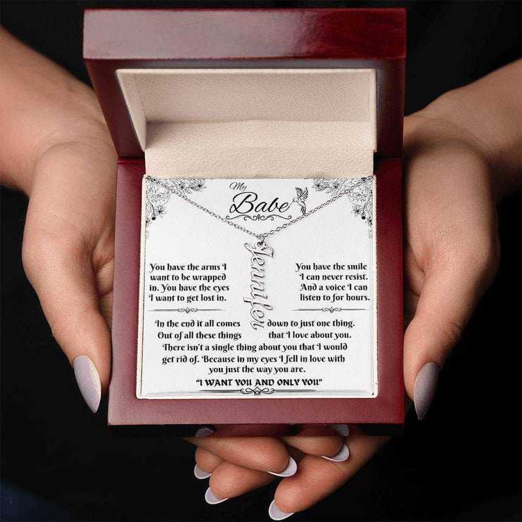 polished stainless-steel vertical name necklace in a luxury box in hands