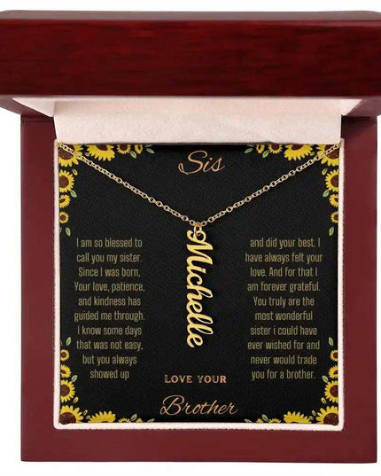 Vertical Name Necklace with a yellow gold finish charm on a to sis from brother greeting card inside of a mahogany box