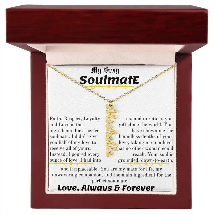 a yellow gold vertical name necklace in a mahogany box