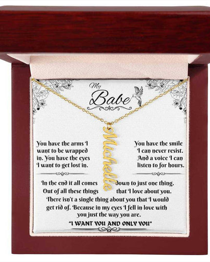 yellow gold vertical name necklace in a luxury box up close