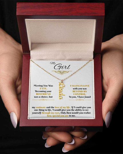 gold vertical name necklace in luxury box in model's hands