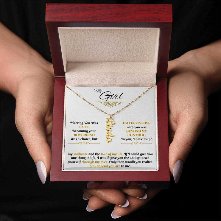 gold vertical name necklace in luxury box in model's hands