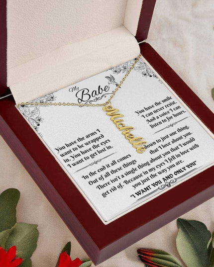 yellow gold vertical name necklace in a luxury box angled left