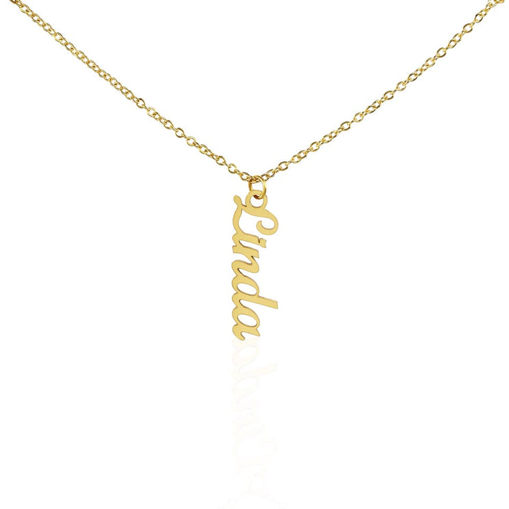 a yellow gold vertical name necklace hanging