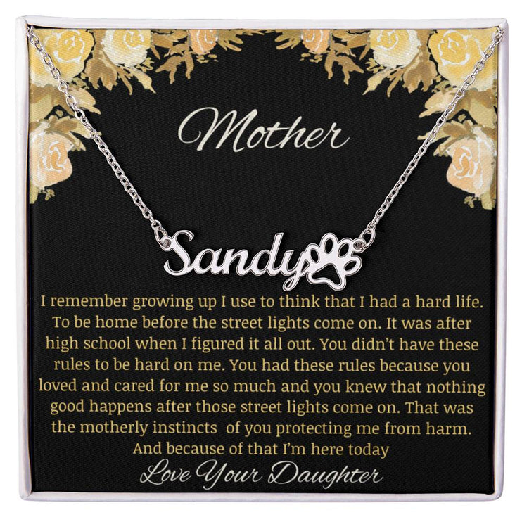 A polished stainless-steel pet name paw print necklace.