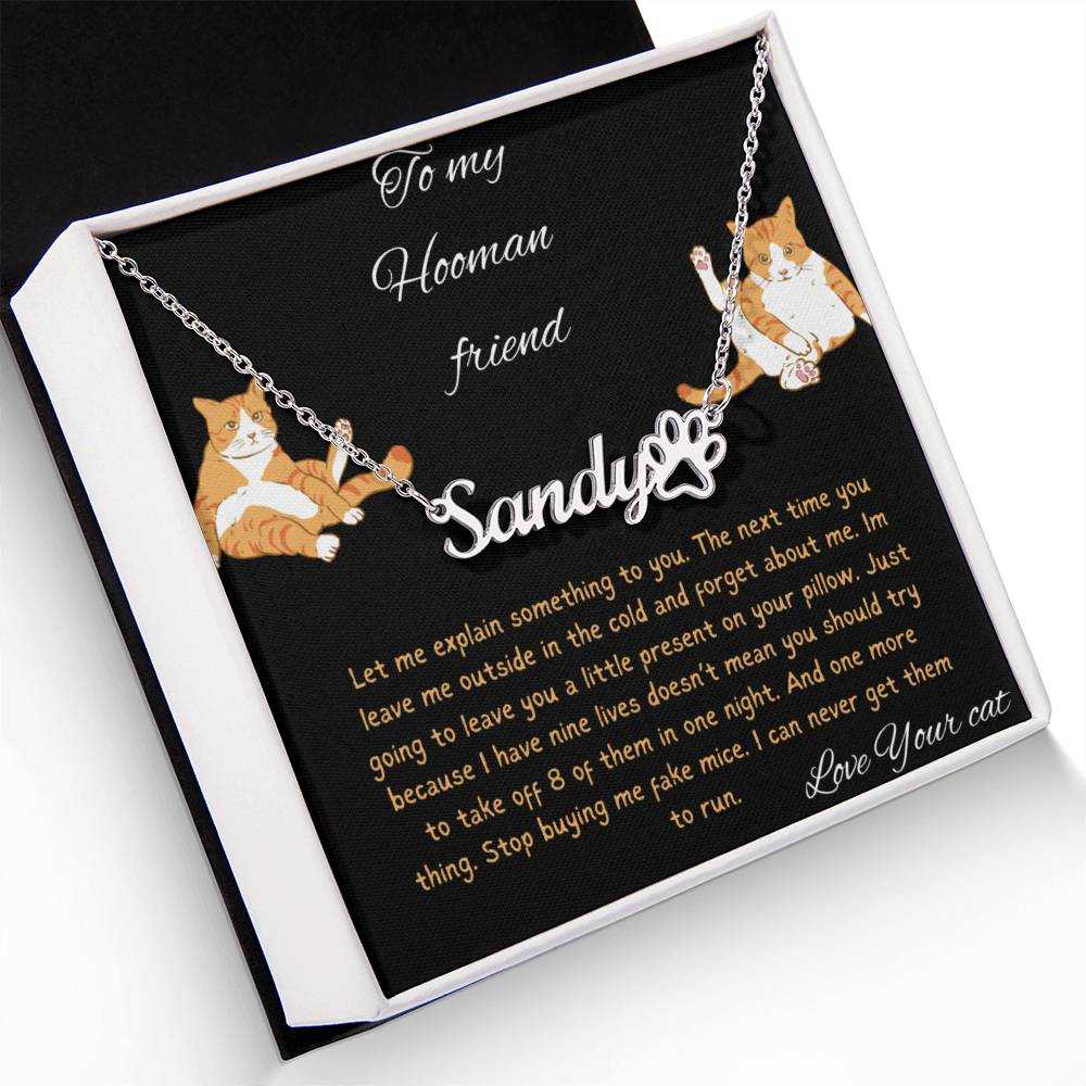 Pet Name Paw Print Necklace with a polished stainless-steel variant on a to my hooman greeting card inside a two-tone box angled slightly to the left with a up close view