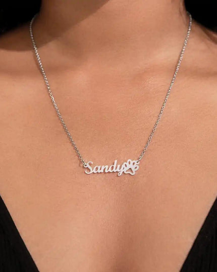 polished steel paw print pet name necklace on model's neck