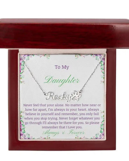 A polished stainless-steel pet name paw print necklace in mahogany box