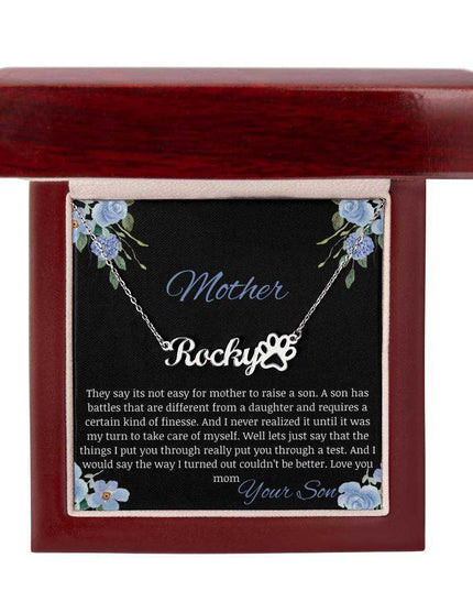 A polished stainless-steel pet name paw print necklace in a mahogany box.