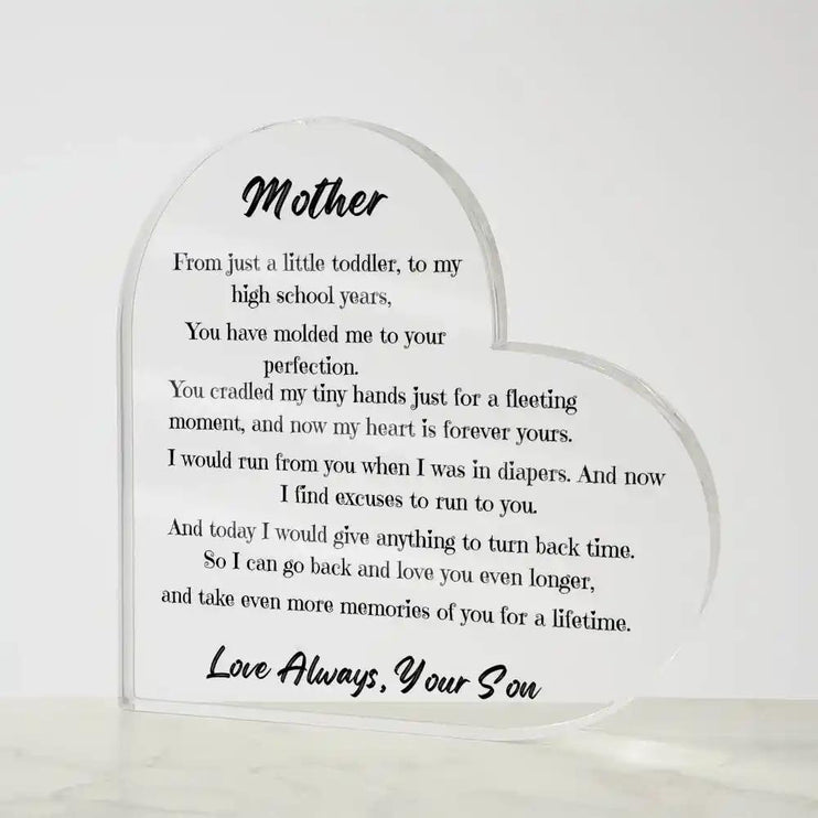 a acrylic heart plaque on a marble table