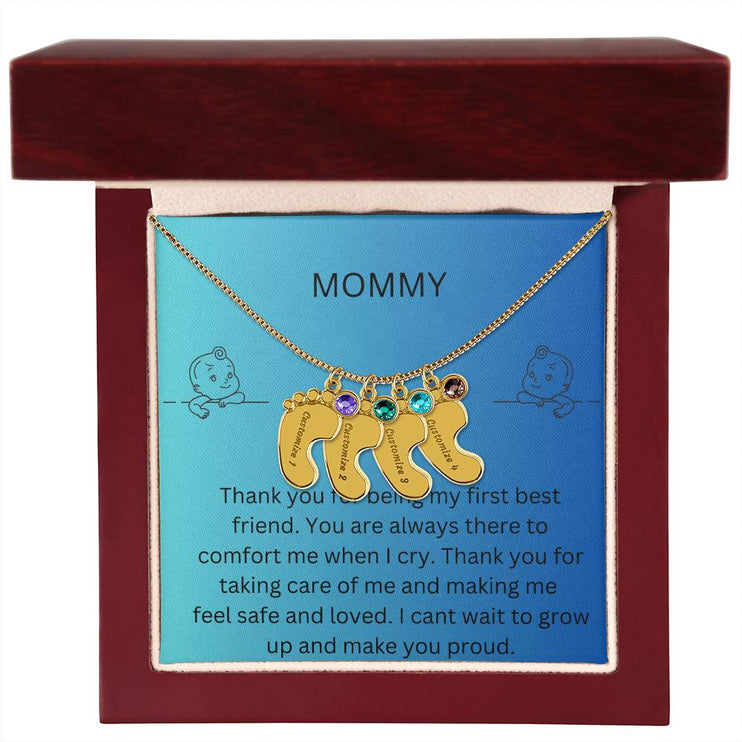 a 4 charm yellow gold baby feet birthstone necklace in a mahogany box