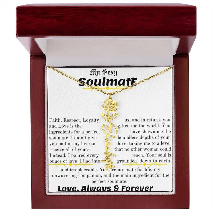 a birth flower name necklace in yellow gold for January in a mahogany box.