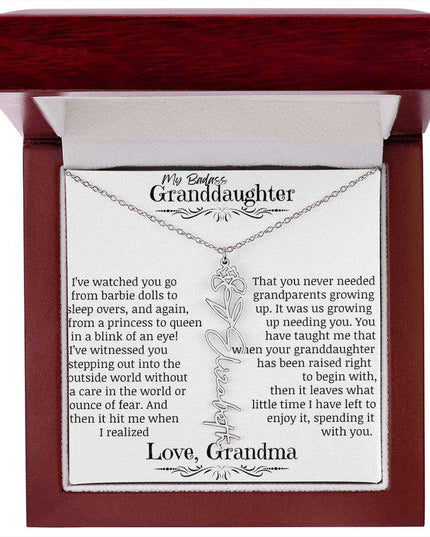 a polished stainless steel flower name necklace for February in mahogany box.