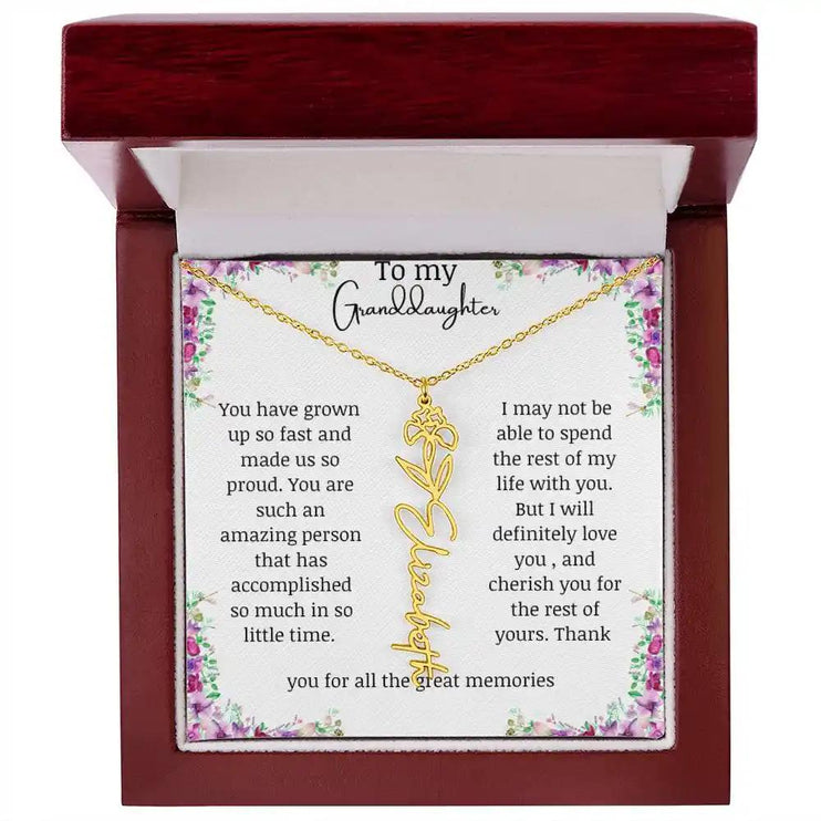 a yellow gold finish February birth flower name necklace in a mahogany box.