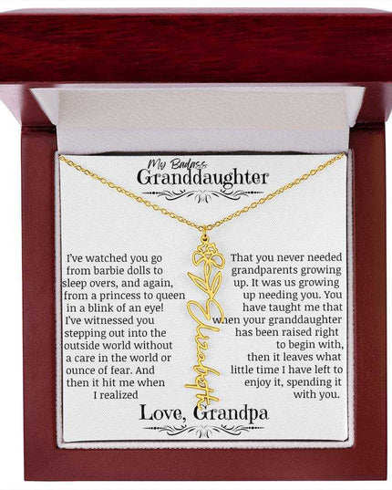a yellow gold flower name necklace j in a mahogany box.