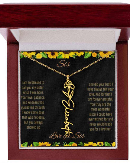 Birth Flower Name Necklace with a yellow gold variant of a flower on a To Sis from Sis message card in a mahogany box up close