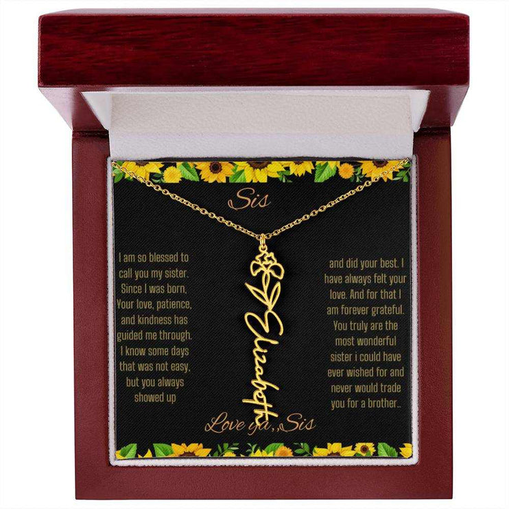 Birth Flower Name Necklace with a yellow gold variant of a flower on a To Sis from Sis message card in a mahogany box up close
