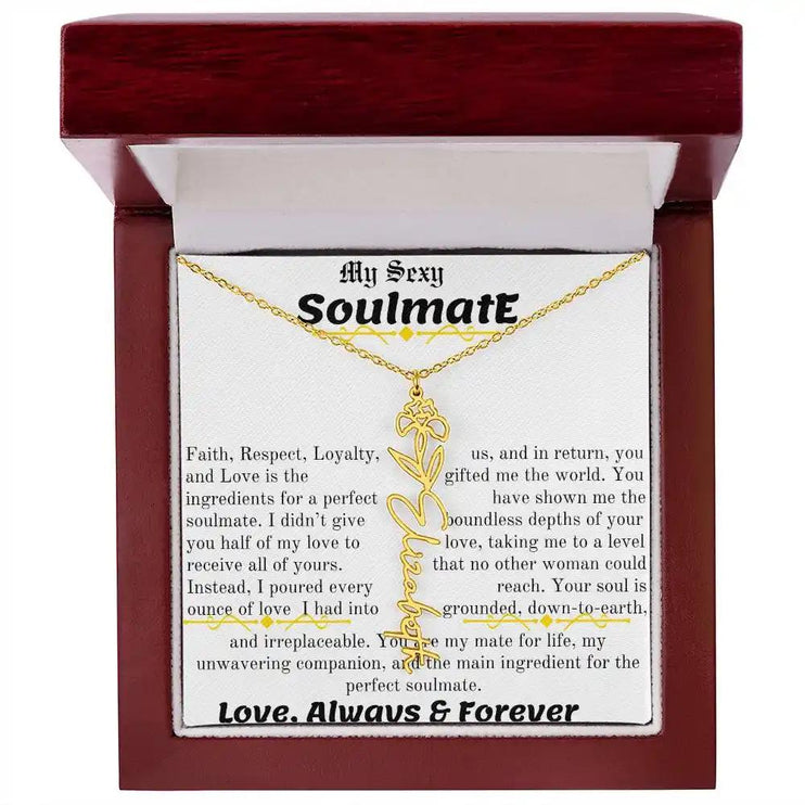 a birth flower name necklace in yellow gold for February in a mahogany box.
