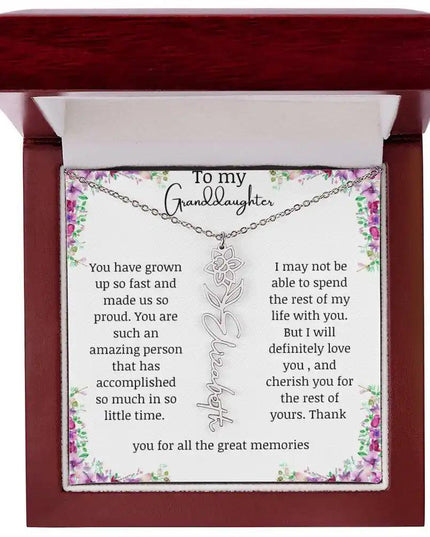 a polished stainless-steel March birth flower name necklace in a mahogany box.
