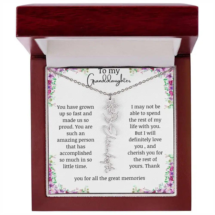 a polished stainless-steel March birth flower name necklace in a mahogany box.